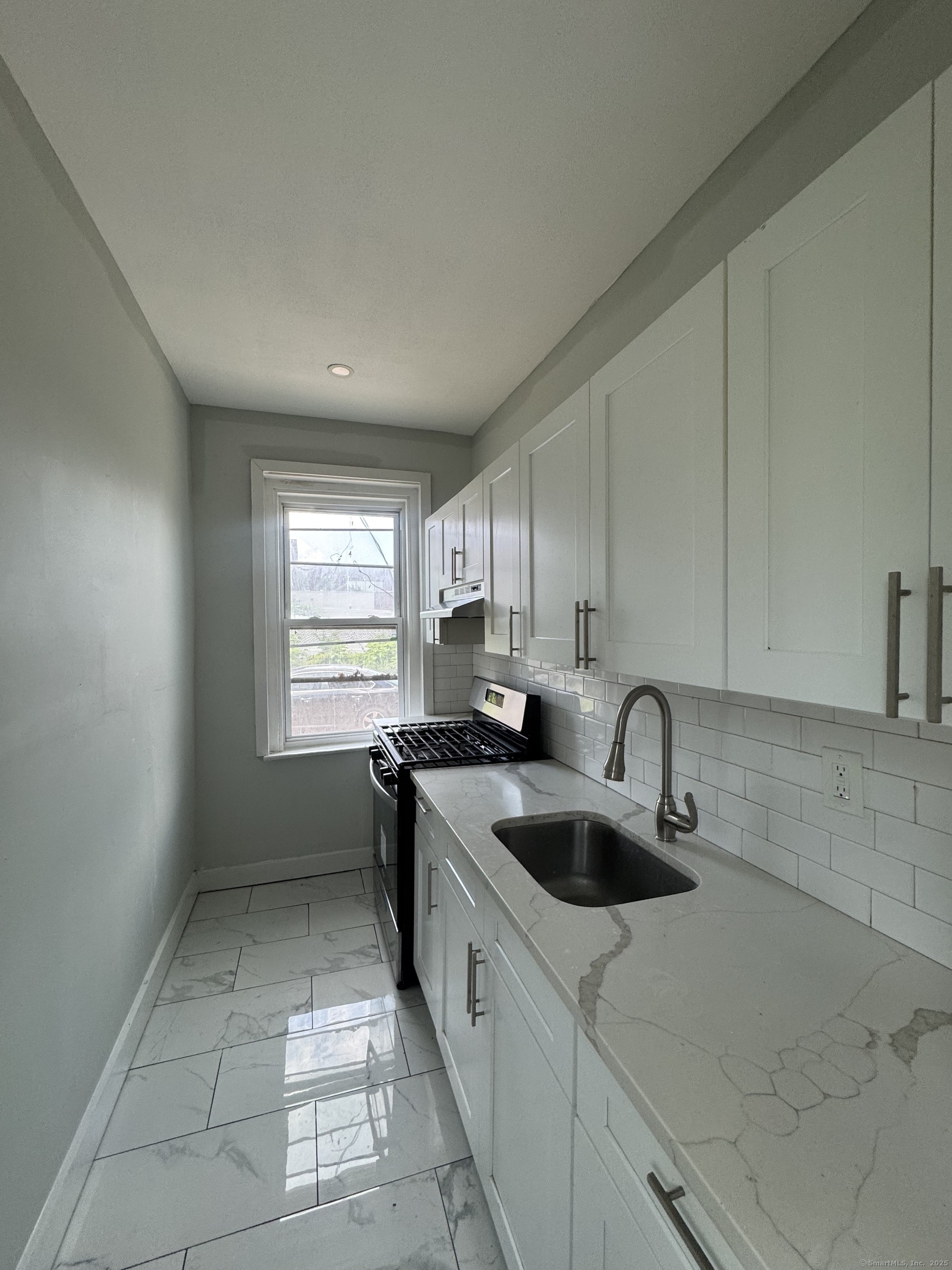 648 Ferry Street, Unit 3 New Haven, CT 06513 - Photo 2 of 9 a kitchen with a sink a counter top space cabinets and stainless steel appliances