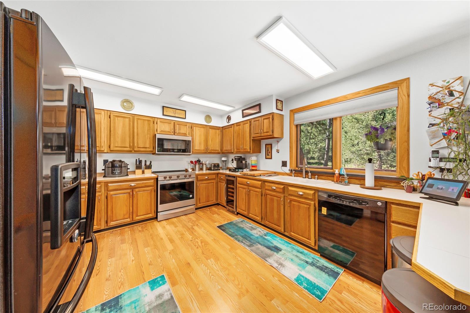 444 Nova Road Pine, CO 80470 - Photo 11 of 40 a kitchen with stainless steel appliances granite countertop a stove and a refrigerator