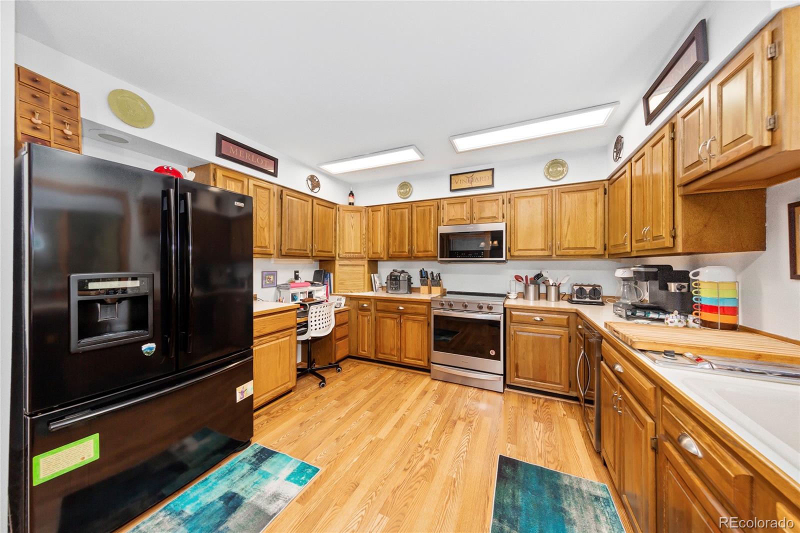444 Nova Road Pine, CO 80470 - Photo 12 of 40 a kitchen with stainless steel appliances and a refrigerator