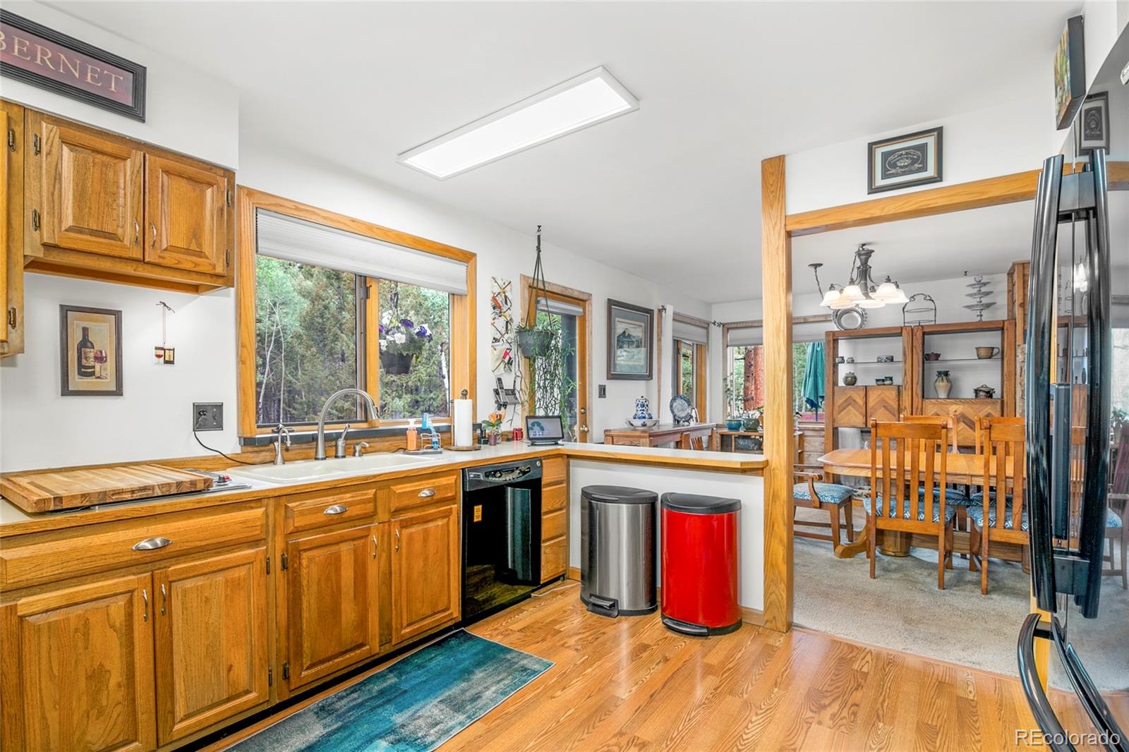 444 Nova Road Pine, CO 80470 - Photo 13 of 40 a kitchen with lots of counter top space and wooden floor
