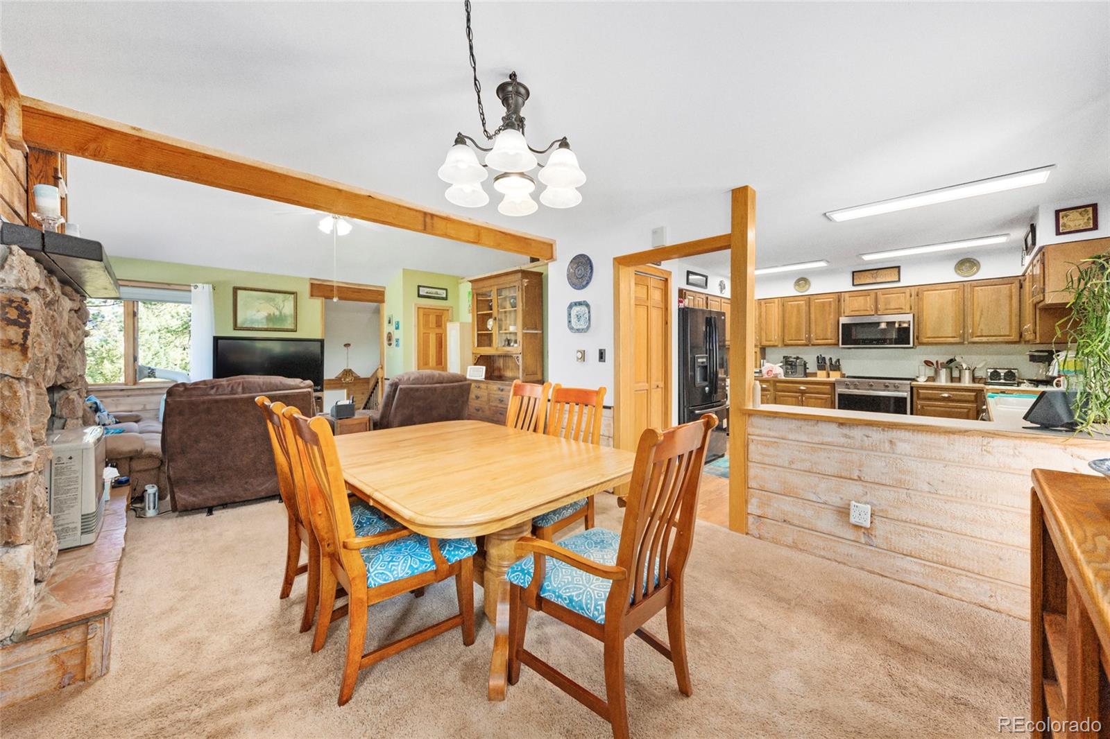 444 Nova Road Pine, CO 80470 - Photo 16 of 40 a view of a dining room with furniture and a chandelier