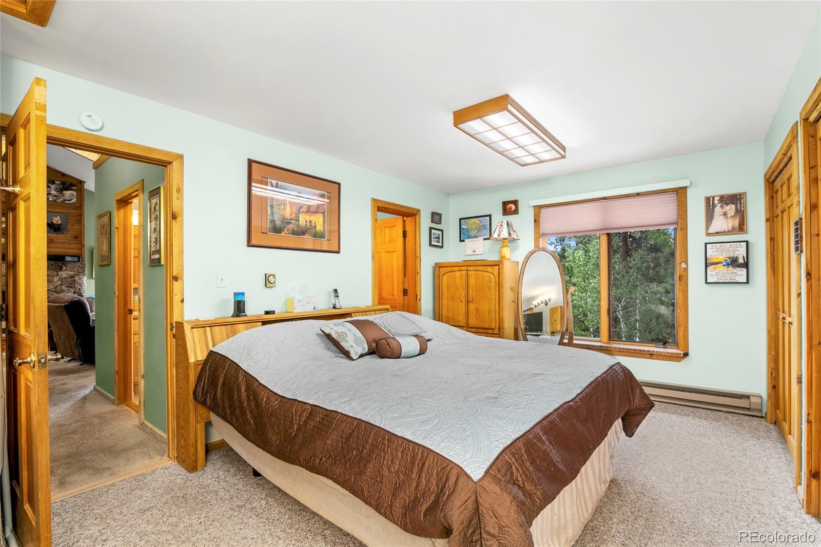 444 Nova Road Pine, CO 80470 - Photo 18 of 40 a bedroom with a bed and a table