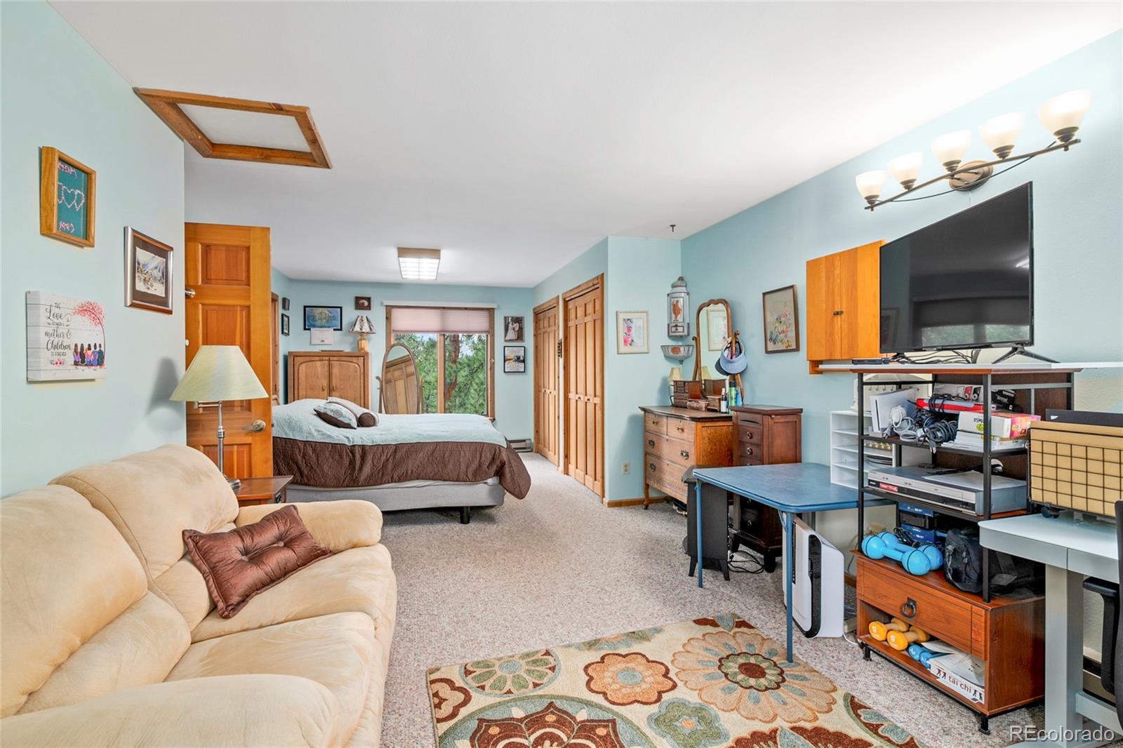 444 Nova Road Pine, CO 80470 - Photo 19 of 40 a living room with furniture and a flat screen tv