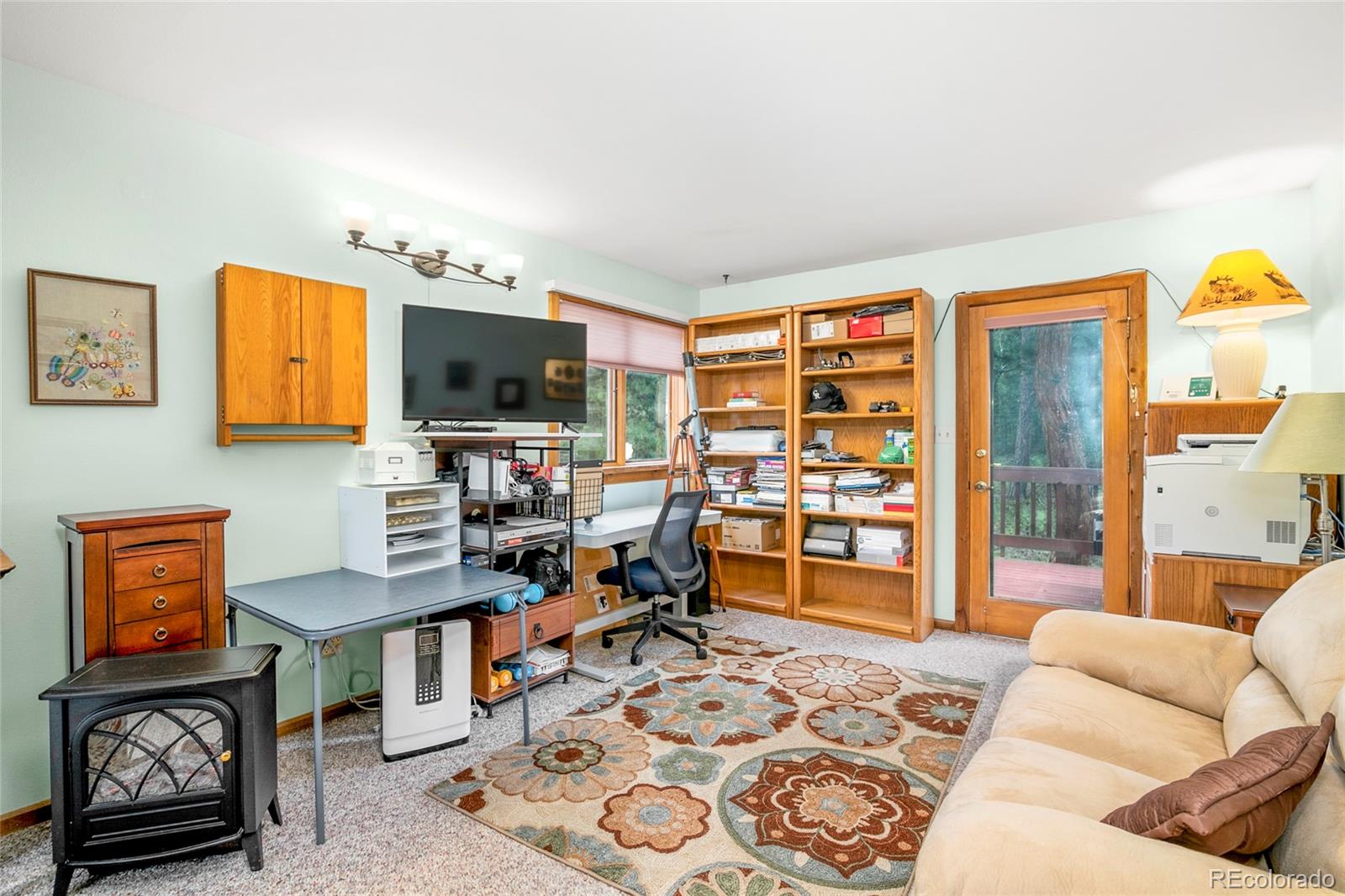 444 Nova Road Pine, CO 80470 - Photo 20 of 40 a living room with furniture a flat screen tv and a window