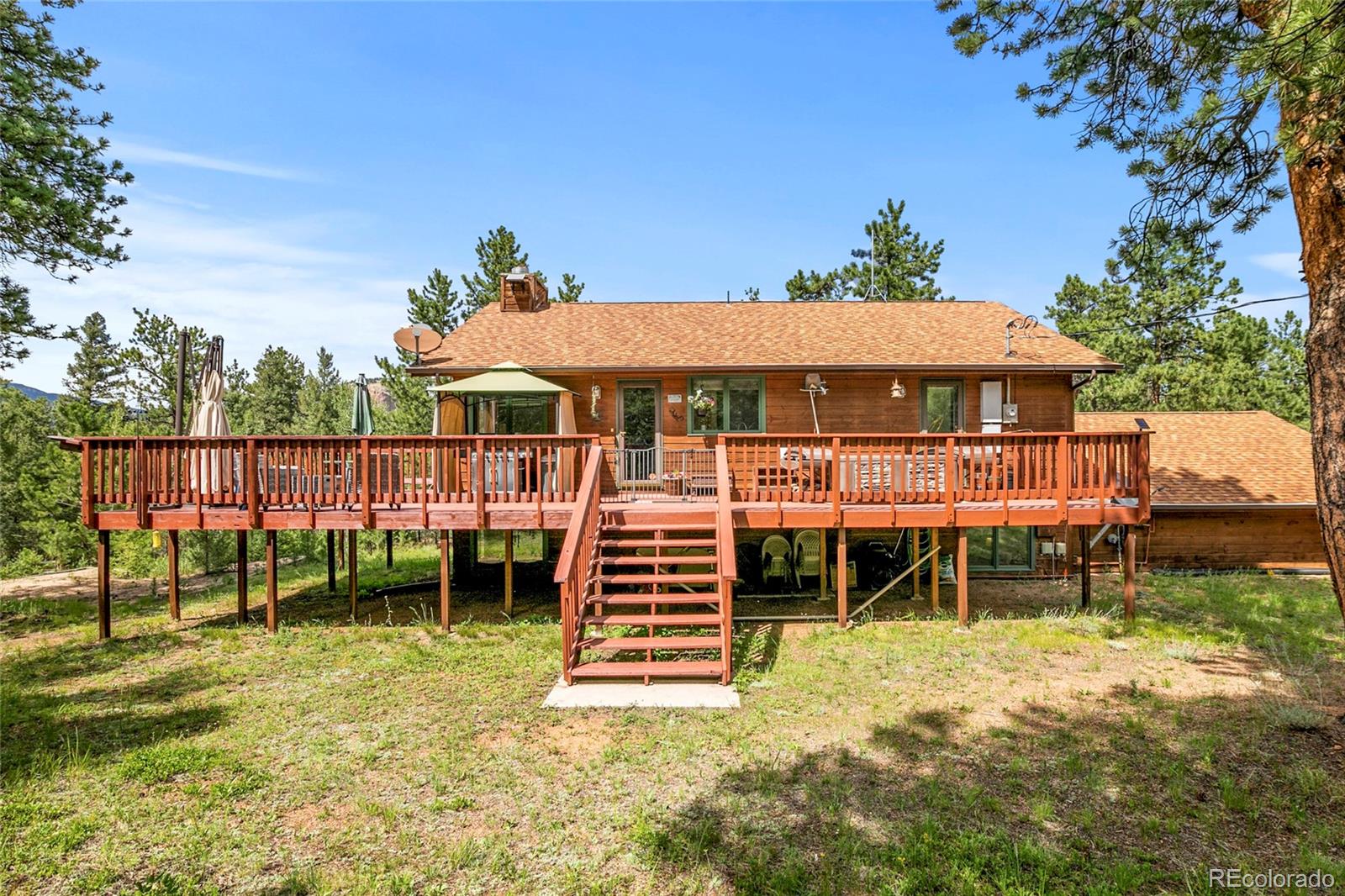 444 Nova Road Pine, CO 80470 - Photo 2 of 40 a view of a house with a yard balcony and sitting area