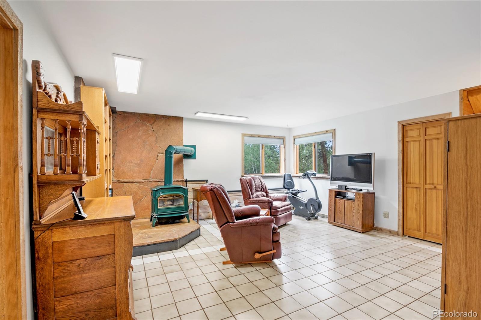 444 Nova Road Pine, CO 80470 - Photo 22 of 40 a living room with furniture and a flat screen tv