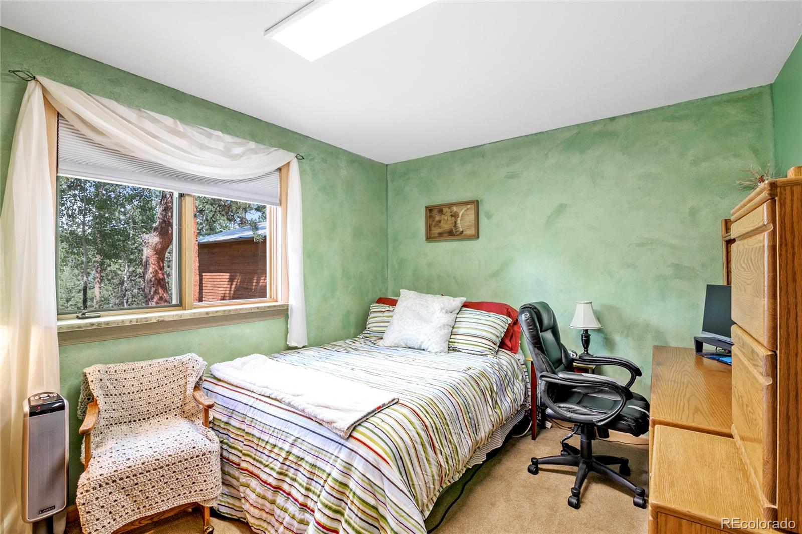 444 Nova Road Pine, CO 80470 - Photo 26 of 40 a bedroom with a bed and a window