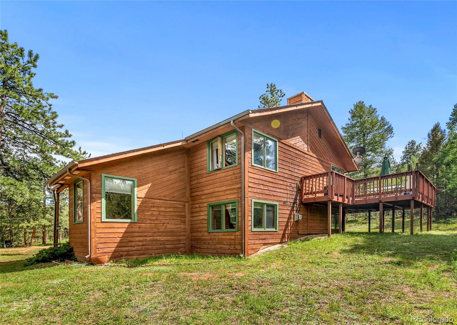 444 Nova Road Pine, CO 80470 - Photo 36 of 40 a view of a house with a yard