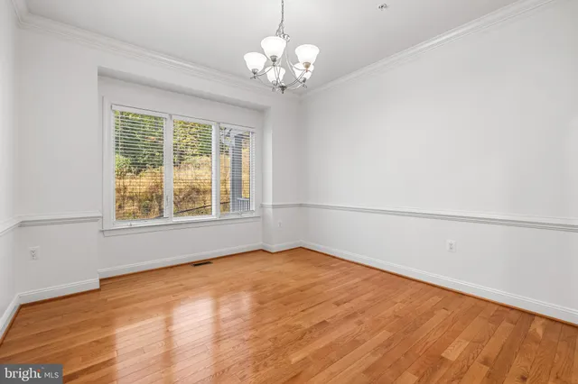 a view of an empty room with a fireplace and a window