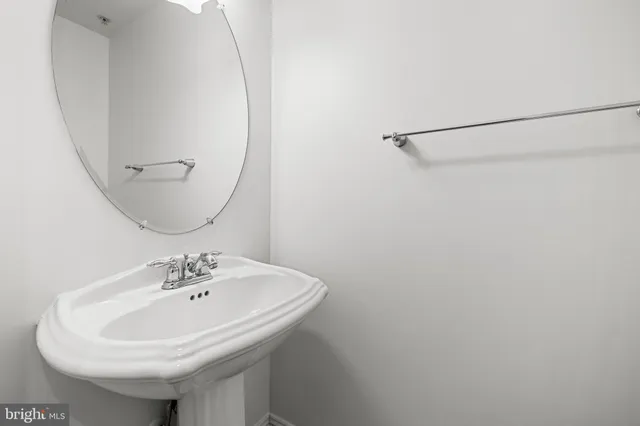 a kitchen with stainless steel appliances kitchen island granite countertop a refrigerator oven a sink dishwasher and white cabinets with wooden floor