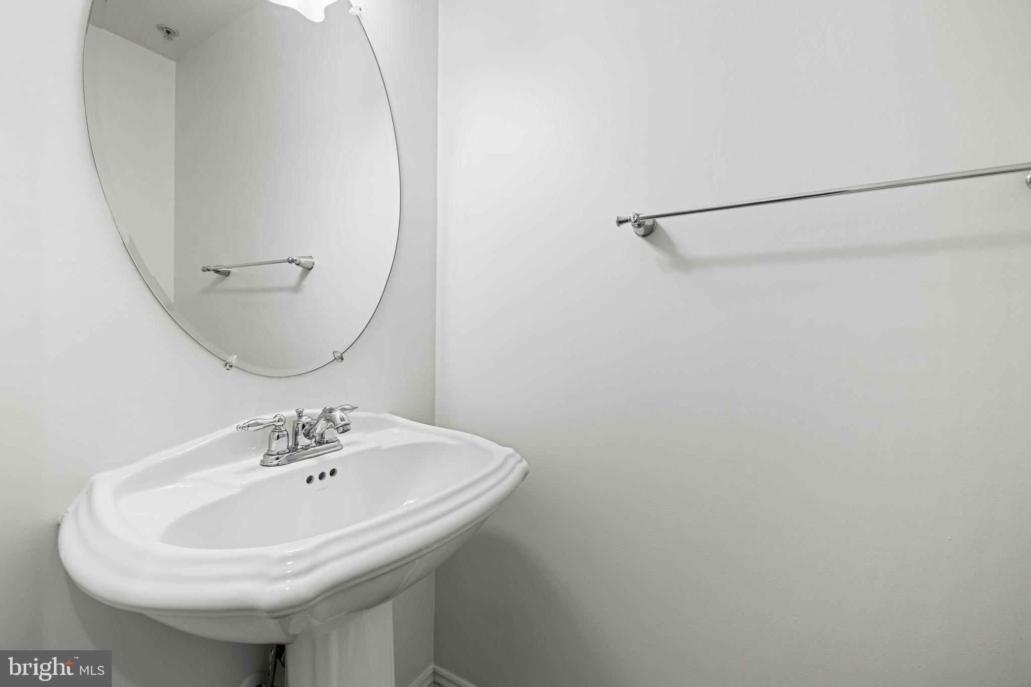 6716 Newstead Lane Baltimore, MD 21209 - Photo 16 of 66 a bathroom with a sink a mirror and vanity