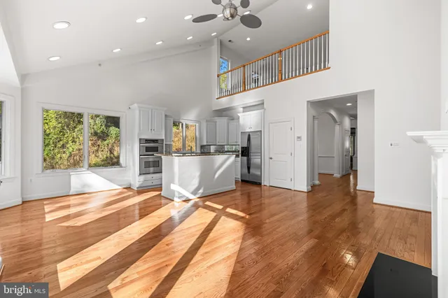 a large kitchen with kitchen island granite countertop a large window