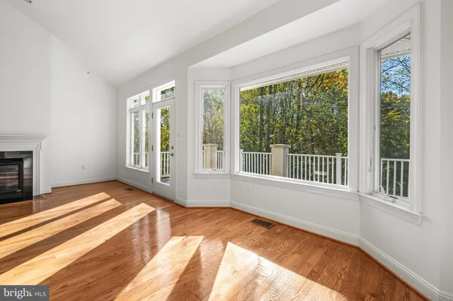 a view of a room with wooden floor and windows