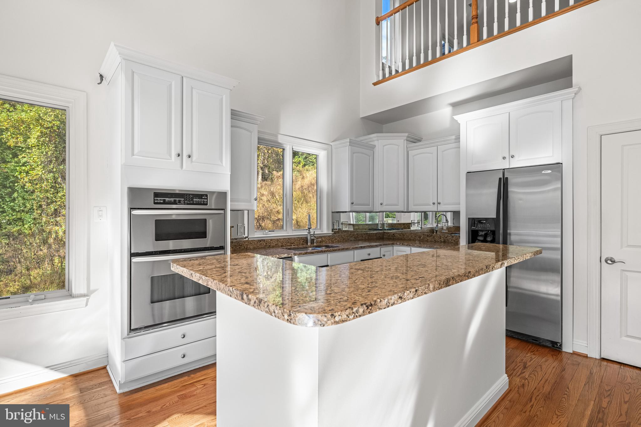 6716 Newstead Lane Baltimore, MD 21209 - Photo 24 of 66 a kitchen with stainless steel appliances granite countertop a refrigerator a stove and a sink with wooden floor
