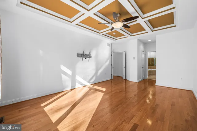 a view of empty room with wooden floor