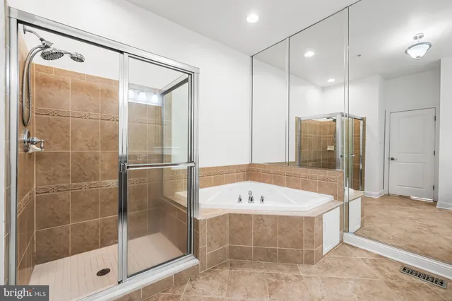 a bathroom with a granite countertop sink a toilet a mirror and shower