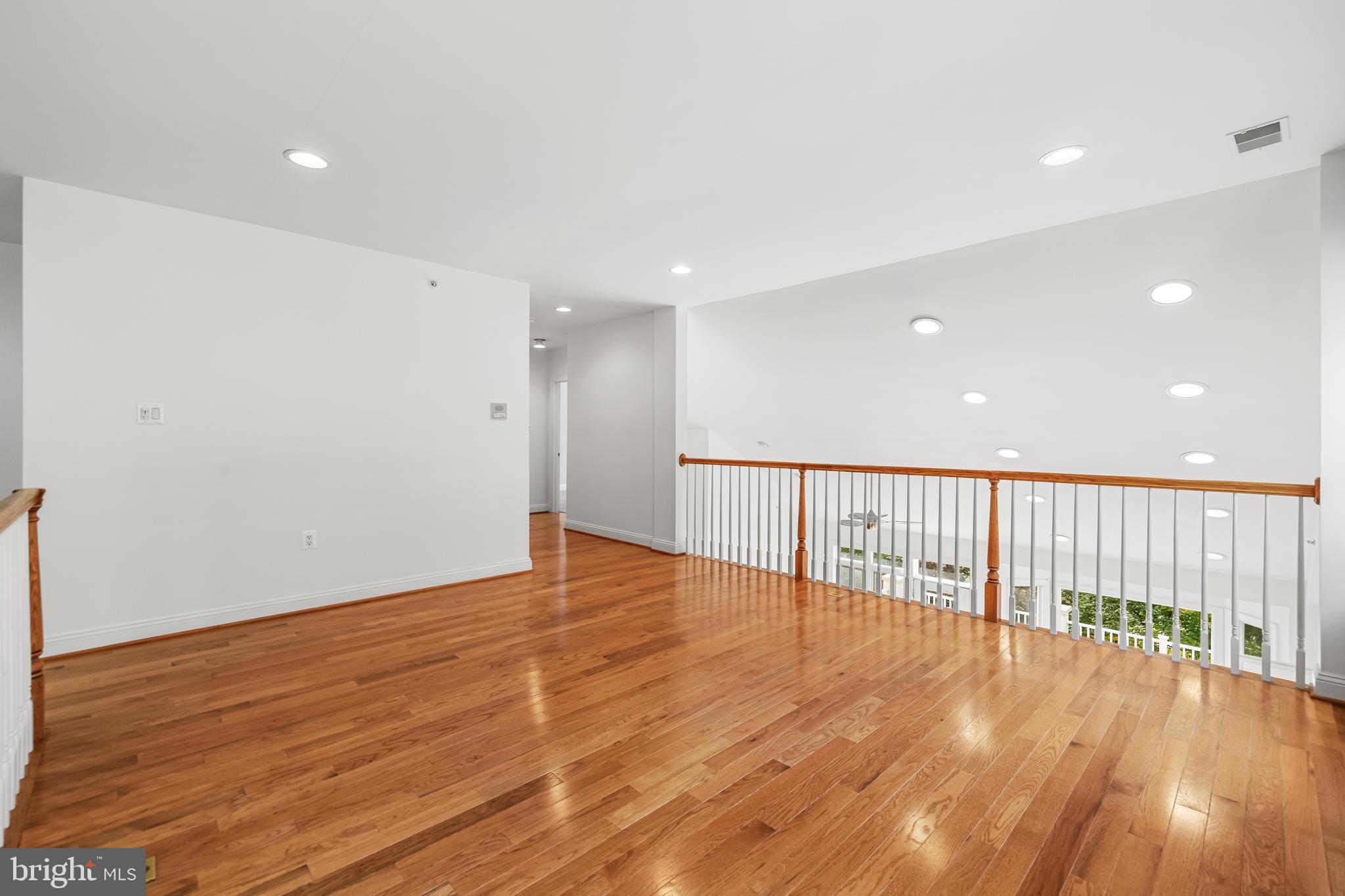 6716 Newstead Lane Baltimore, MD 21209 - Photo 41 of 66 a view of an empty room with wooden floor