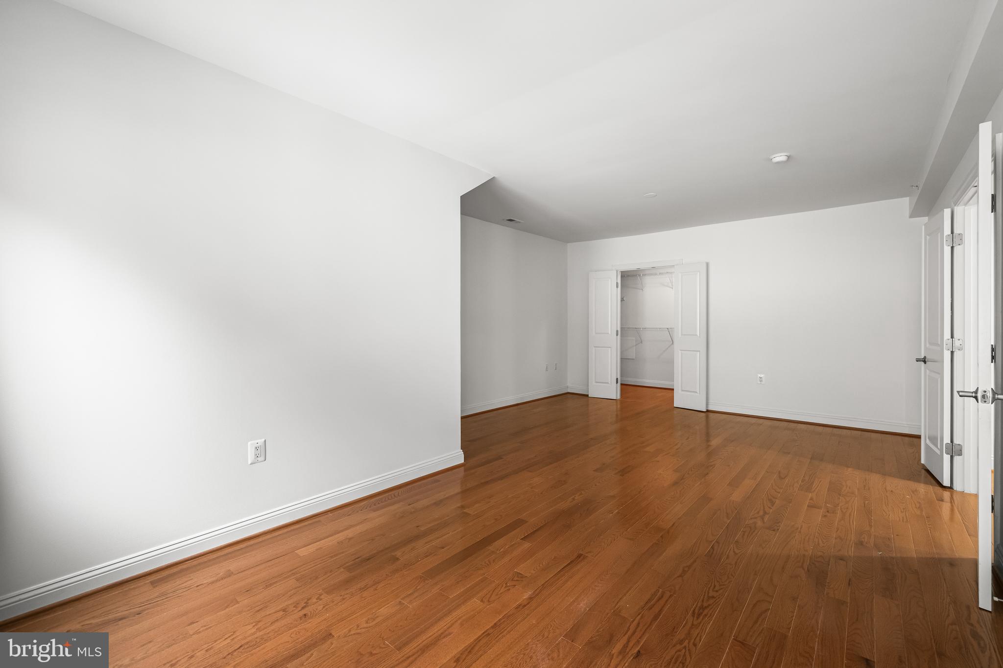 6716 Newstead Lane Baltimore, MD 21209 - Photo 45 of 66 a view of empty room with wooden floor
