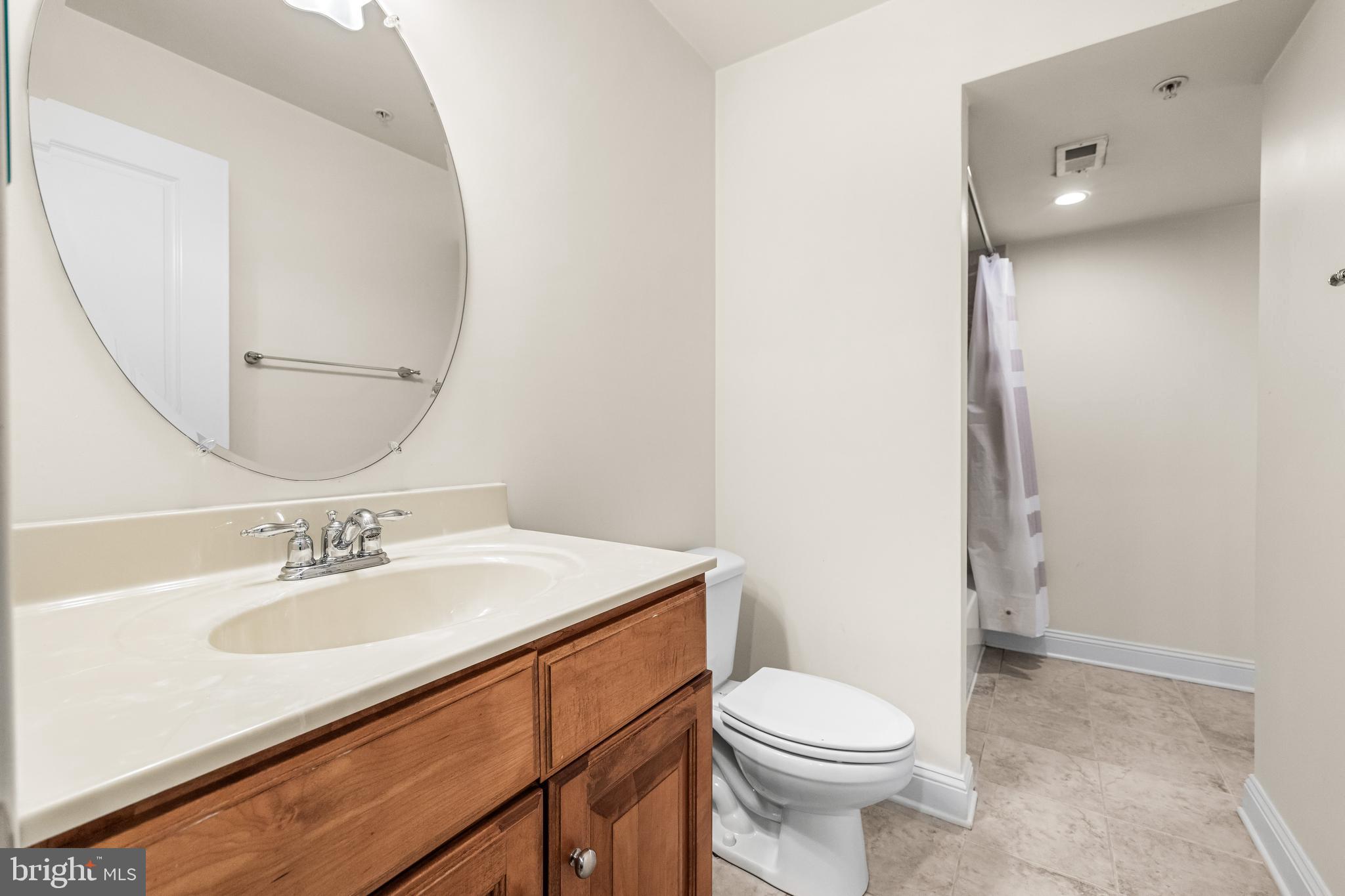 6716 Newstead Lane Baltimore, MD 21209 - Photo 62 of 66 a bathroom with a sink toilet and mirror