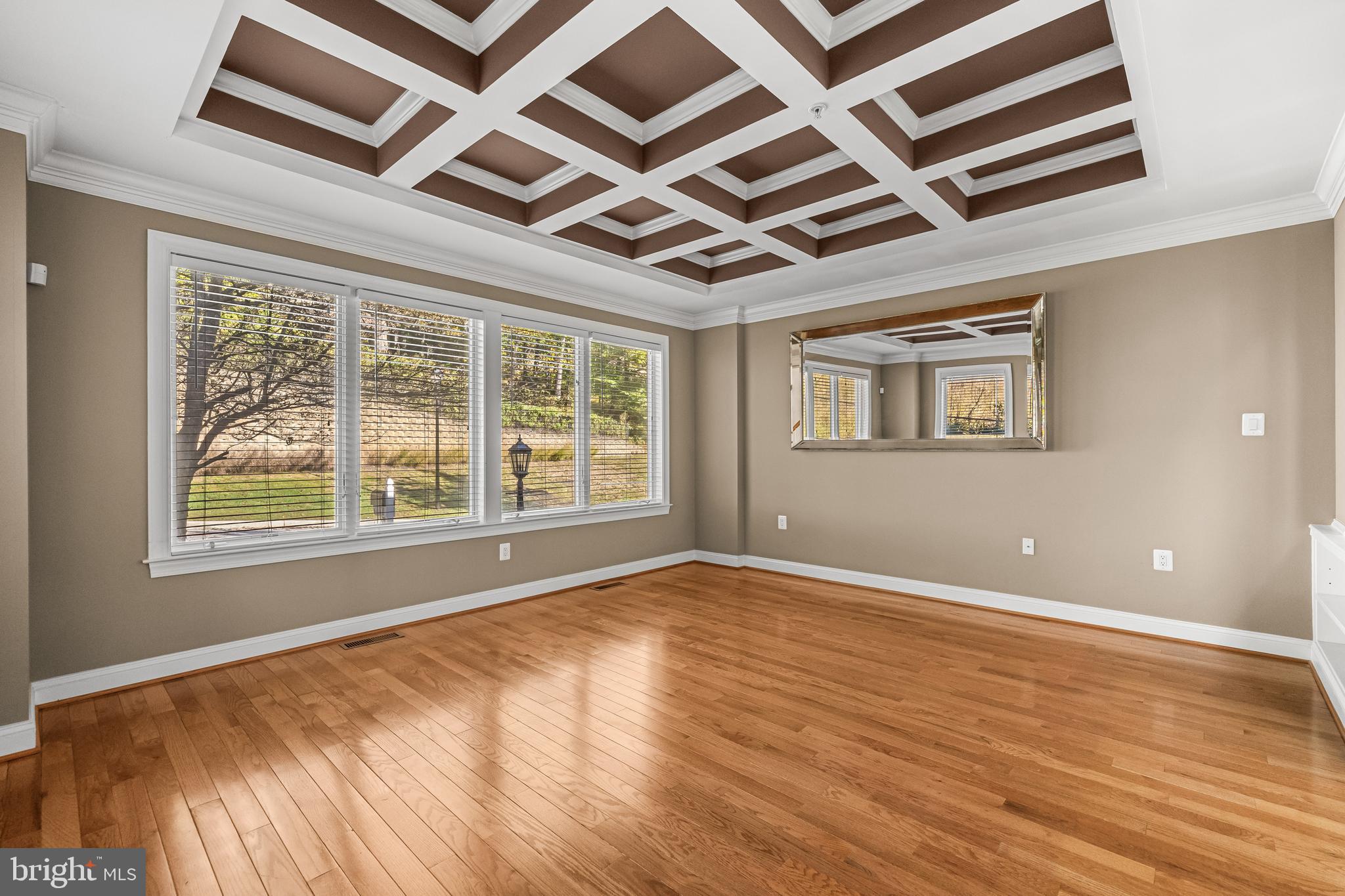 6716 Newstead Lane Baltimore, MD 21209 - Photo 8 of 66 a view of an empty room with wooden floor and a window