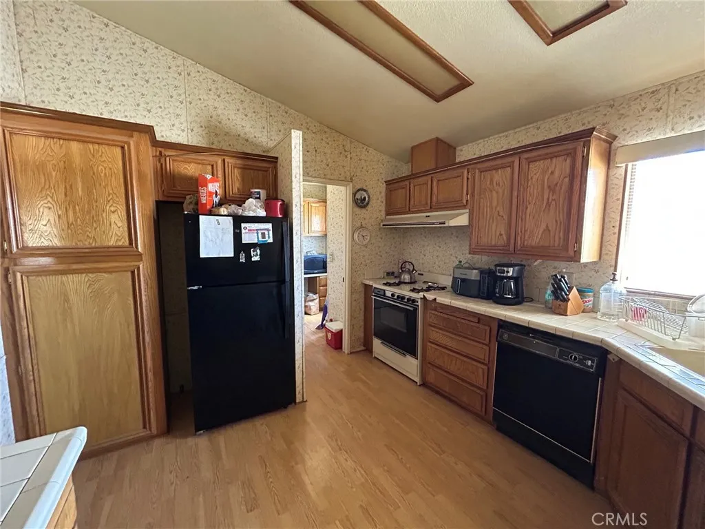 27250 Murrieta Road, Unit 347 Menifee, CA 92586 - Photo 10 of 38 a kitchen with stainless steel appliances granite countertop a refrigerator and a sink