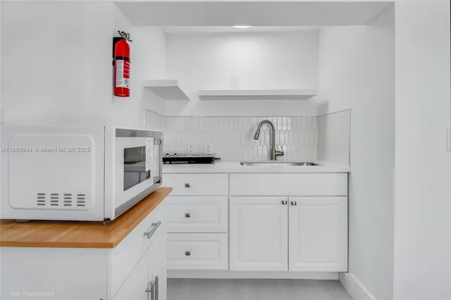 a bathroom with cabinets and a sink