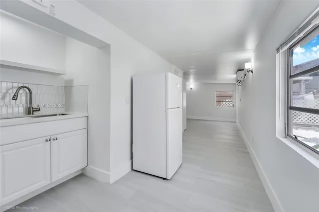 a bathroom with a double vanity sink a mirror and a shower