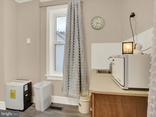 a room with a refrigerator and a window