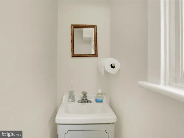 a bathroom with a sink mirror and vanity