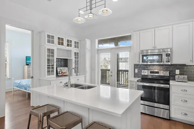 a kitchen with a table chairs stove and cabinets