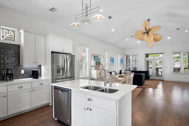 a kitchen with stainless steel appliances kitchen island a white cabinets and sink