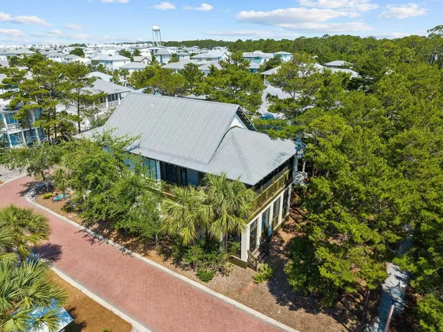 an aerial view of a house with a yard and lake view