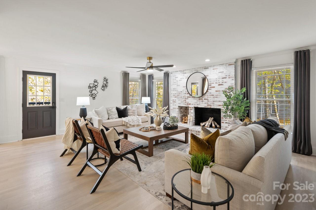 4215 Kuykendall Road Charlotte, NC 28270 - Photo 11 of 43 a living room with furniture a fireplace and a large window
