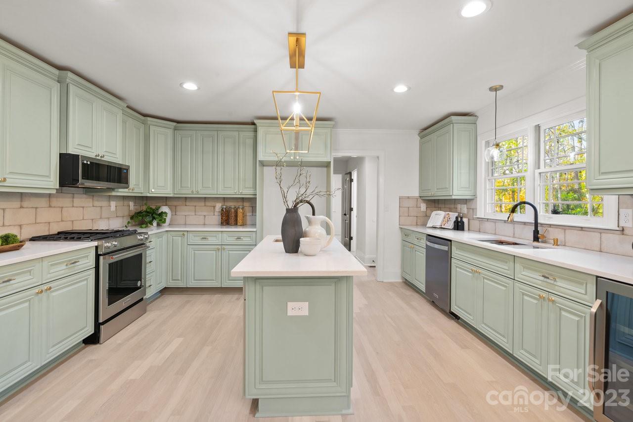 4215 Kuykendall Road Charlotte, NC 28270 - Photo 12 of 43 a kitchen with granite countertop a sink stainless steel appliances and cabinets