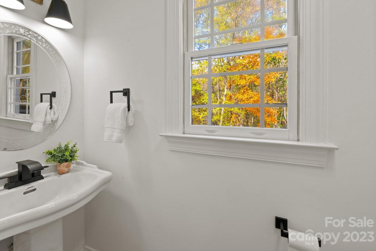 4215 Kuykendall Road Charlotte, NC 28270 - Photo 21 of 43 a bathroom with a sink a mirror and a window
