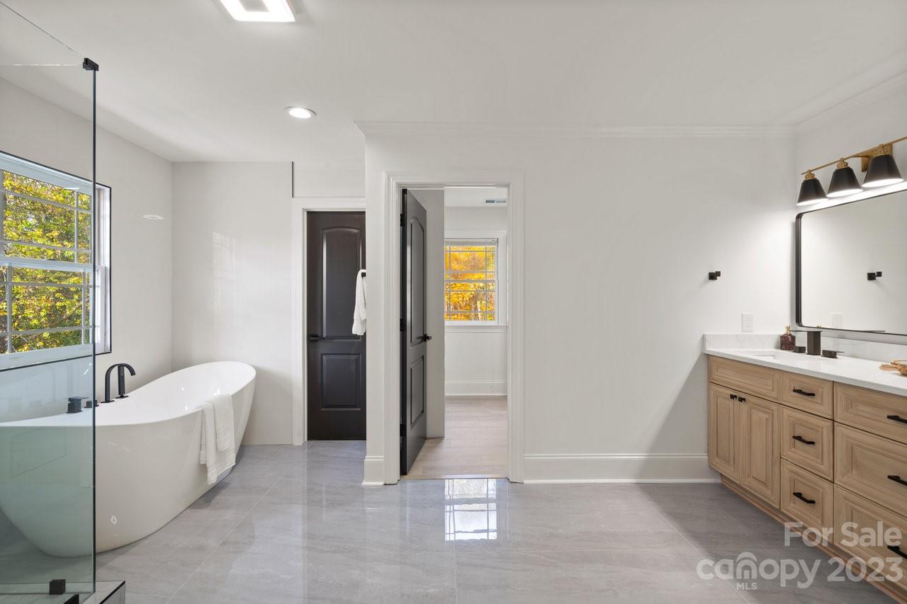 4215 Kuykendall Road Charlotte, NC 28270 - Photo 26 of 43 a spacious bathroom with a double vanity sink a mirror and a bathtub