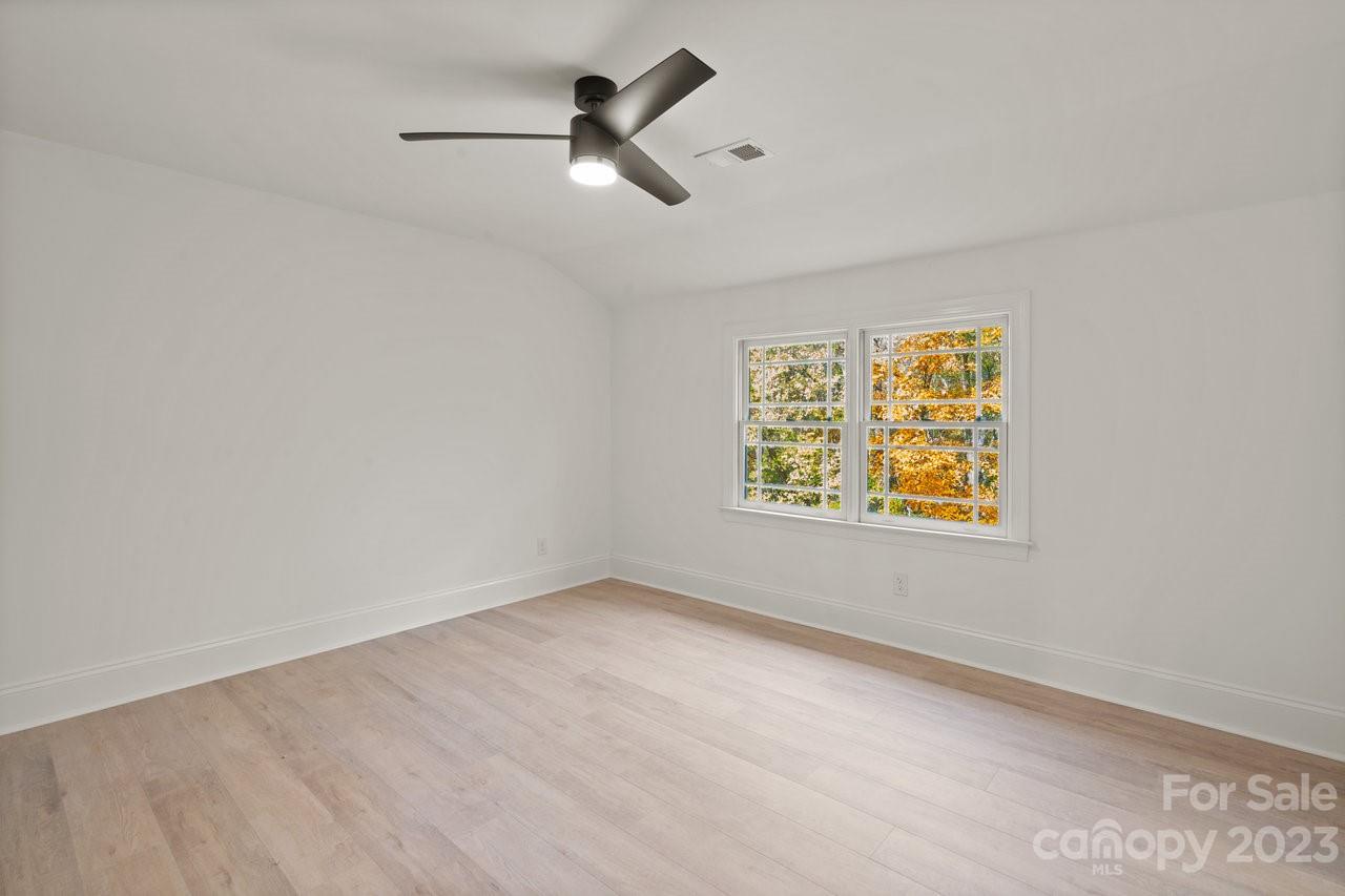 4215 Kuykendall Road Charlotte, NC 28270 - Photo 32 of 43 an empty room with windows and ceiling fan view