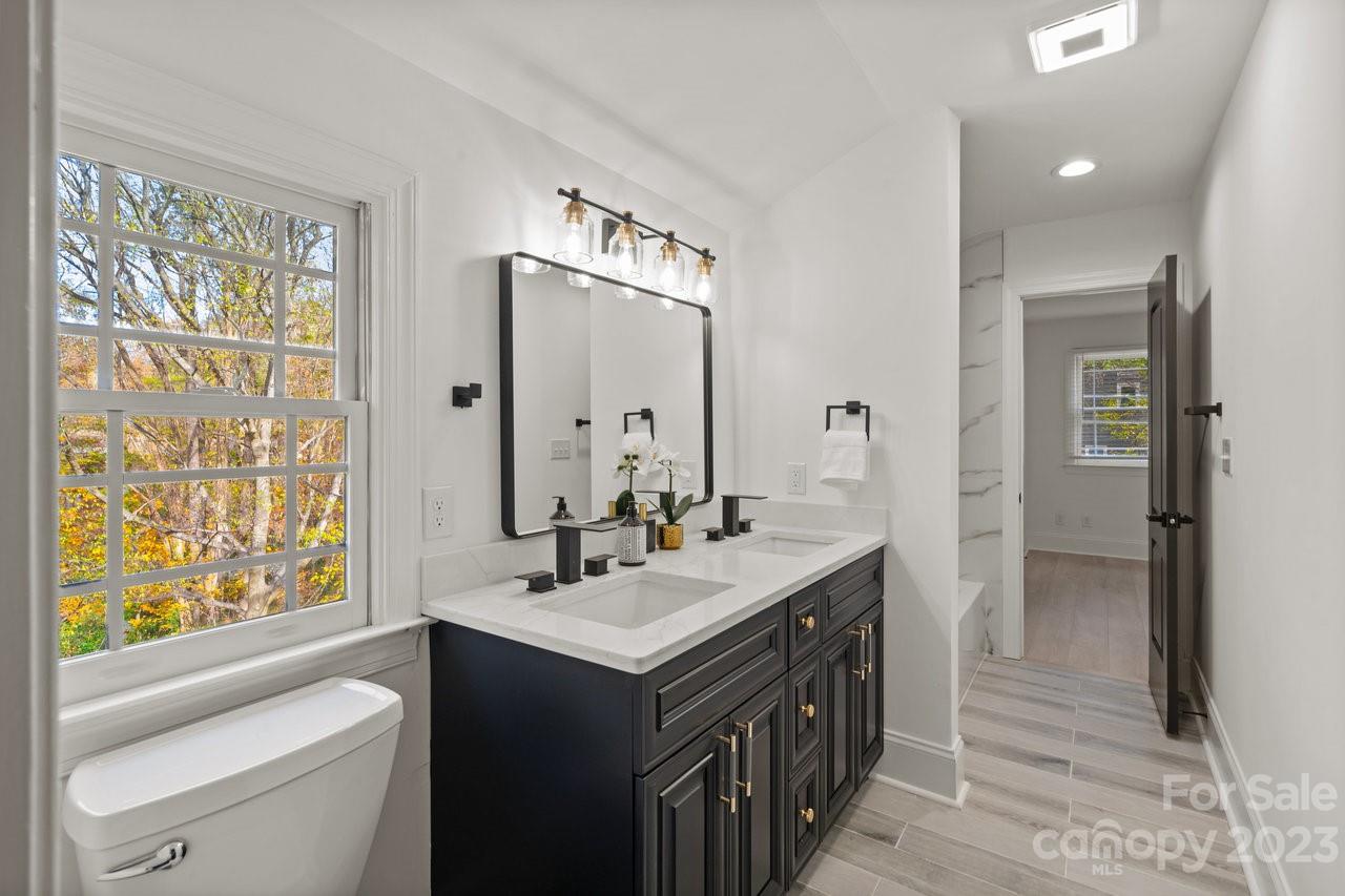 4215 Kuykendall Road Charlotte, NC 28270 - Photo 33 of 43 a bathroom with a double vanity sink a mirror and a bathtub