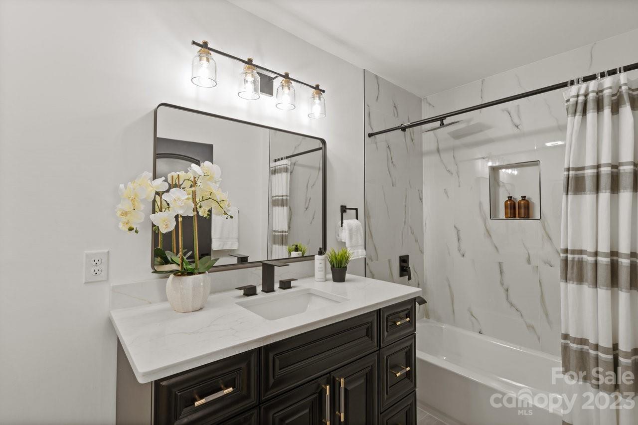 4215 Kuykendall Road Charlotte, NC 28270 - Photo 34 of 43 a bathroom with a sink and a mirror