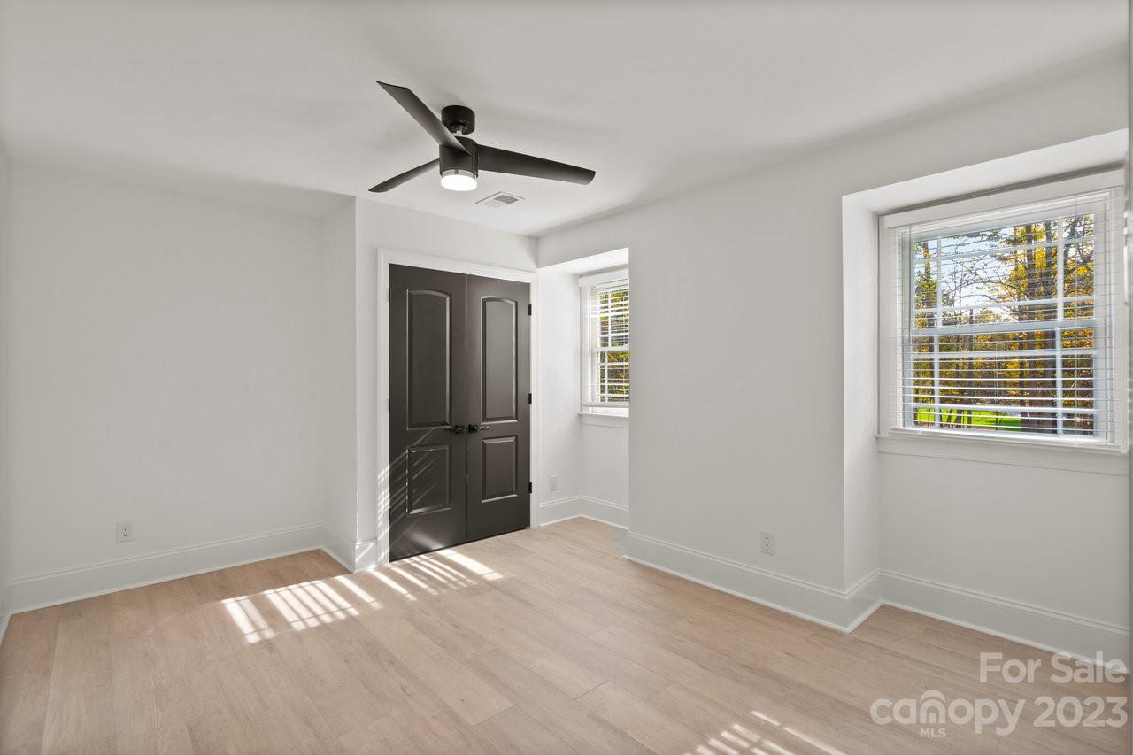 4215 Kuykendall Road Charlotte, NC 28270 - Photo 36 of 43 a view of empty room with wooden floor and ceiling fan