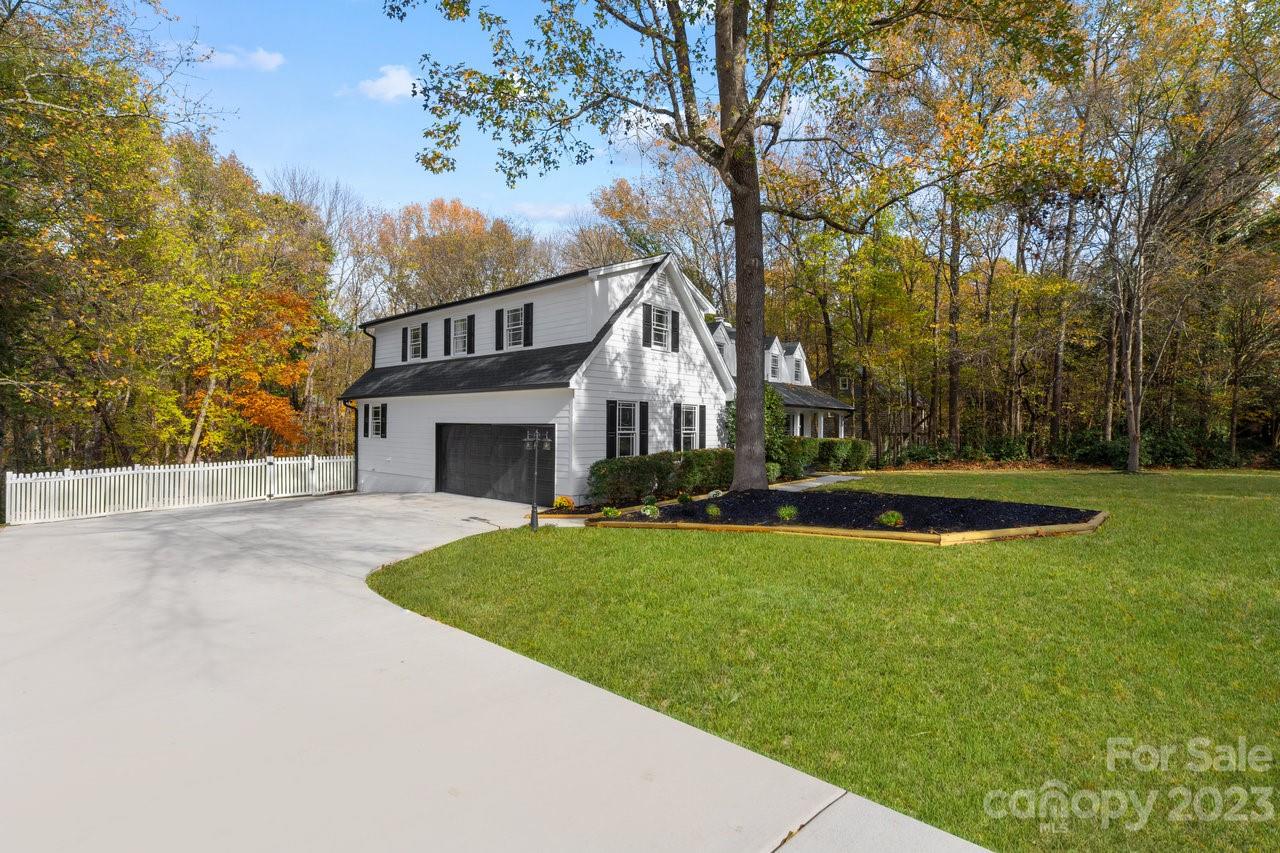 4215 Kuykendall Road Charlotte, NC 28270 - Photo 6 of 43 a view of a house with a big yard plants and large trees