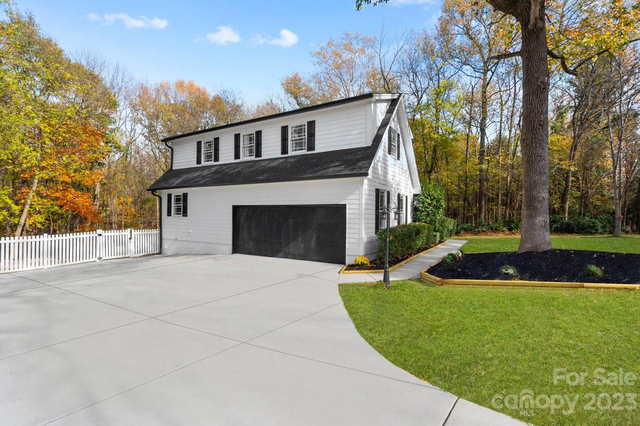 4215 Kuykendall Road Charlotte, NC 28270 - Photo 8 of 43 a front view of a house with a yard and garage