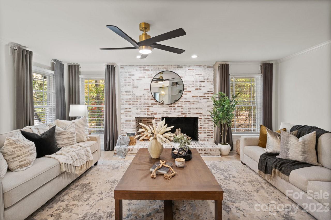 4215 Kuykendall Road Charlotte, NC 28270 - Photo 10 of 43 a living room with furniture a fireplace and a large window