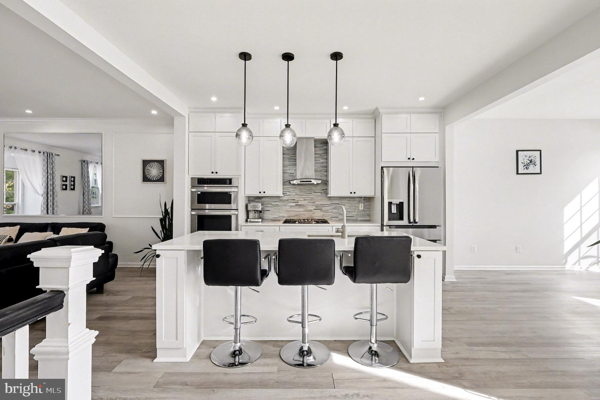 a view of kitchen with dining area refrigerator and wooden floor