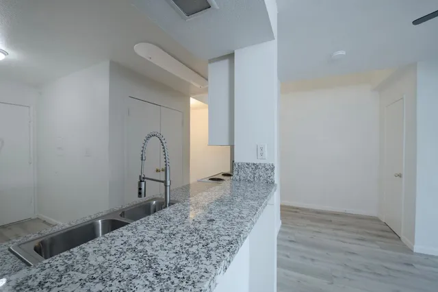 a view of a sink and cabinets