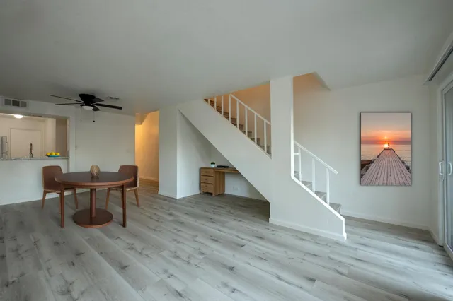 a view of a livingroom with furniture and stairs
