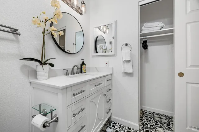 a bathroom with a sink a vanity and a mirror