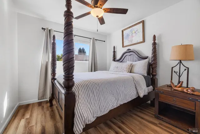 a bedroom with a bed and a lamp on the dresser