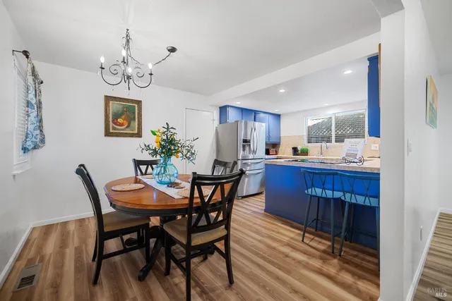 a view of a dining room with furniture wooden floor and a chandelier