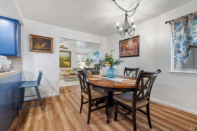 a view of a dining room with furniture wooden floor and a chandelier